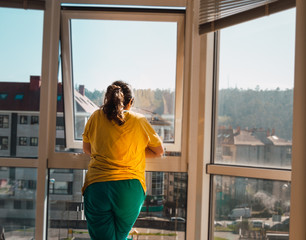 Woman looking through window