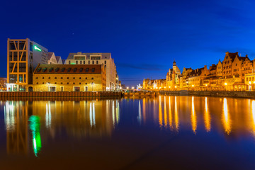 Old town in Gdansk with reflection in Motlawa river at night, Poland.