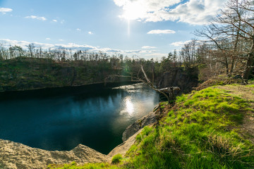Fototapeta na wymiar Water filled stone quarry in Brandis, Saxony, Germany