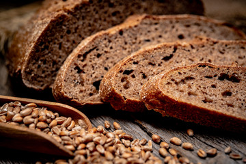 Freshly baked traditional bread on wooden table.