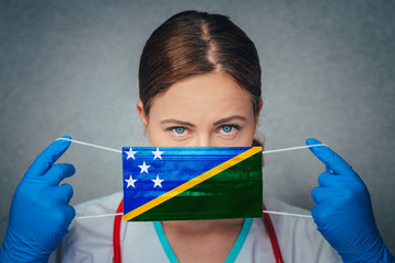 Coronavirus in Solomon Islands Female Doctor Portrait hold protect Face surgical medical mask with...