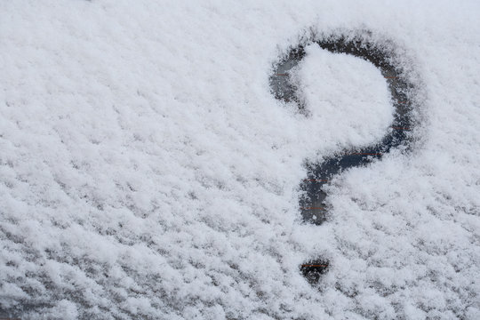 A question mark is drawn on a snowy surface.