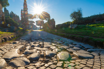 A stretch of the Via Appia, one of the most important streets of the Roman Empire photographed at first light in the morning. This road connected Rome to Brindisi, an important port in ancient Italy.