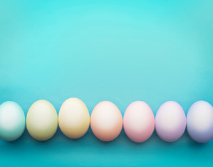 Colorful easter eggs in a row on a blue background