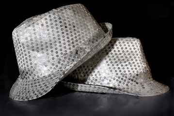 Silver sequin party hat on reflecting black background