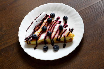 Gentle curd casserole with raisins on a dark background. Top view.