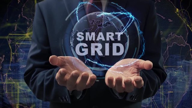 Male hands activate a conceptual holographic text Smart Grid. Businessman in a suit with a hologram of planet Earth on a background of a futuristic wireframe city