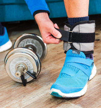 Man With Ankle Weight During Home Workout Close Up