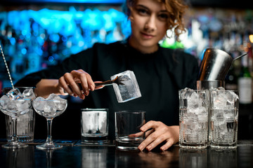 Close-up of several glasses with ice stand on bar counter