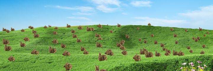 Osterhase und viele Hasen auf einer Wiese zu Ostern © Robert Kneschke