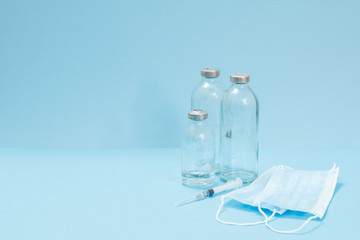 Medical masks, syringe and bottles for liquid medicine.