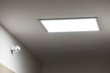 Large led lighting panel on the ceiling in a modern residential complex. Power saving. Motion...