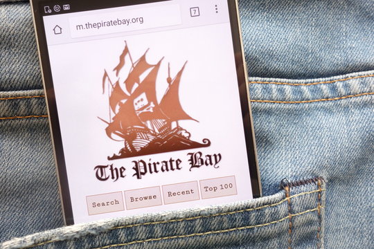 KONSKIE, POLAND - MAY 19, 2018: The Pirate Bay website displayed on smartphone hidden in jeans pocket