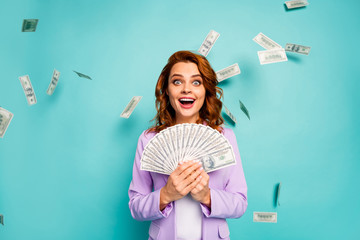 Omg I win lottery.Crazy shocked red hair woman hold money fan cant believe her luck scream wow wear...