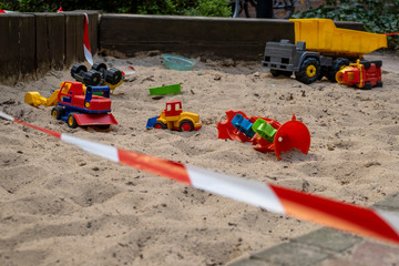 Corona crisis - Children's playground cordoned off with a red and white barrier tape in the...
