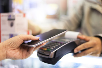 customer paying with credit card. Focus on hands.