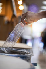 A man throw rubbish in the trash can by separate garbage to dispose like hazardous waste