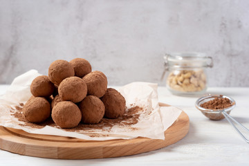 Energy balls with dates, cashew and cocoa. Light concrete background. Good nutrition concept. Raw food.