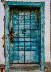 old wooden blue door with the horse shoe in the middle