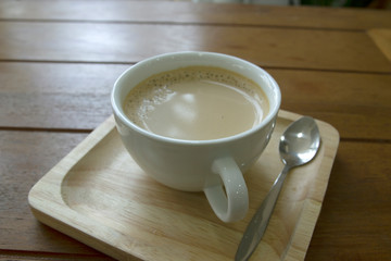 Coffee in a white mug on a wooden table