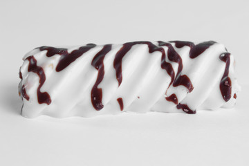 delicious white cake marshmallow sticks with condensed milk on a white background