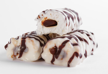 delicious white cake marshmallow sticks with condensed milk on a white background