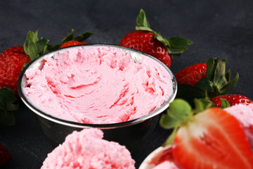 Strawberry ice cream scoop with fresh strawberries