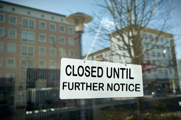 Sign on a shop window with the inscription closed until further notice 