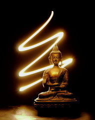 Buddha statue with black background and glowing light