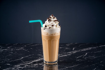 Glass cold brew coffee with ice and milk on black or dark background