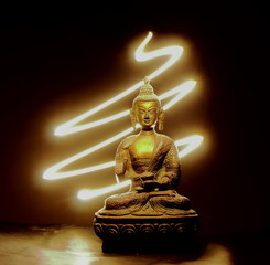 Buddha statue with black background and glowing light