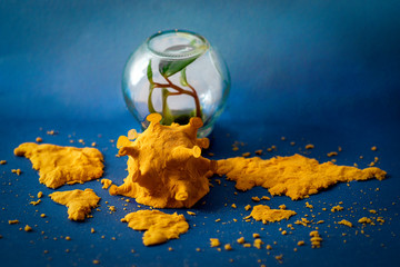 Volumetric image of coronavirus and contours of continents from kinetic sand of orange color, on a...