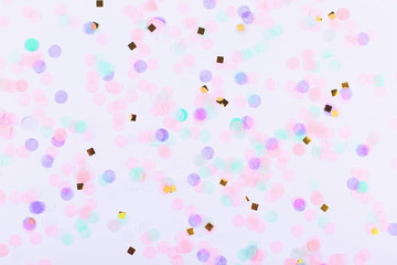 Colorful confetti on white background. Flatlay.