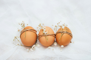 Decorated brown chicken's eggs on white background. Eeco-friendly egg production. Bakery...