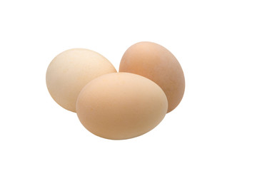  three cream-colored chicken eggs on a white background