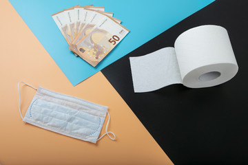 Protective mask and toilet paper, toilet paper, money Concept: panic from a coronavirus. Value of...