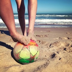 soccer ball on the sand near the sea