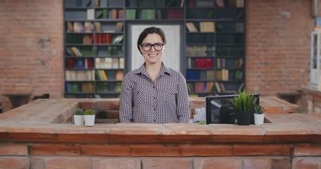 Portrait of woman librarian at work welcoming visitors - Powered by Adobe