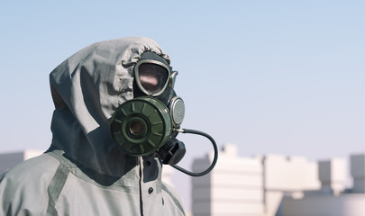 A man in a gas mask and a protective suit. Side view. Empty city in the background.