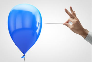 Blue balloon and needle in hand. © Happyphotons