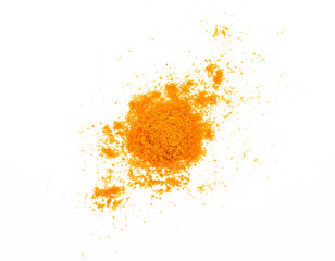 Turmeric powder spreading over a white background. Top view