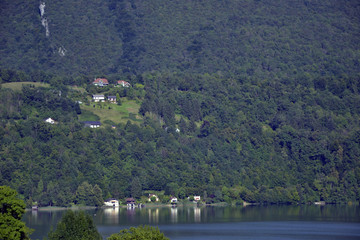 Fototapeta na wymiar View of the alpine lake Aiguebelette, at the feet of a big mountain.