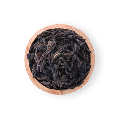Dried tea leaves in a wooden cup Isolated on a white background. top view.