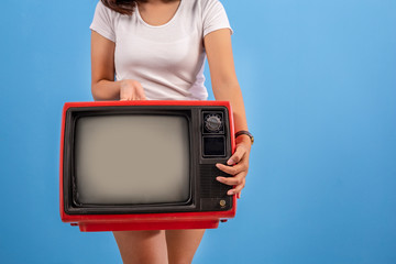 Woman holding red retro old television