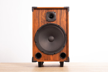Loudspeaker box on wooden table on white background © Pituk