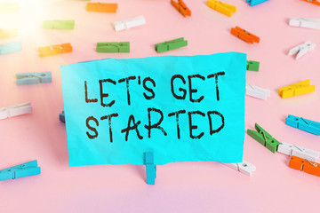 Conceptual hand writing showing Lets Is Get Started. Concept meaning to begin doing or working on something you had started Colored clothespin papers empty reminder pink floor office