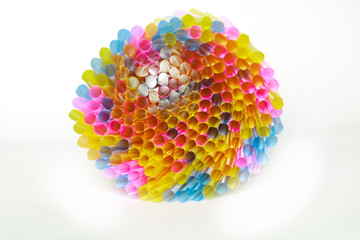 Plastic straws and earth globe, world pollution concept. Single use straws are on the war on plastic. There are plans to ban the sale of plastic straws to help reduce pollution