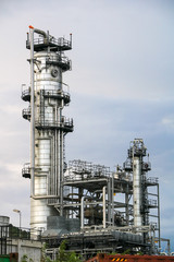 Petrochemical, petroleum, refinery at sunset, cloudy sky