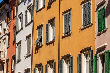 Fototapeta na wymiar Facade of generic houses with many windows and shutters in a street in Trentino Alto Adige, Italy, Europe