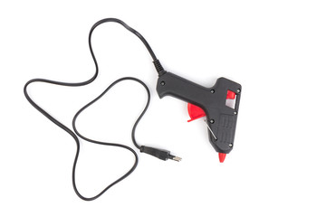 Electric hot glue gun on white background. Rods for glue gun
